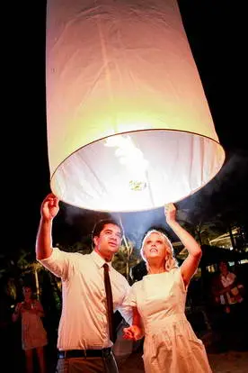 newlywed couple release flying lantern on their beach wedding in Koh Tao